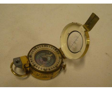 A Second War Officer's brass marching compass by T G Co. Ltd London dated 1942
