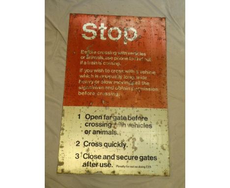 An aluminium British Railway's level crossing sign "STOP Before Crossing With Vehicles And Animals Use Phone To Find Out If A