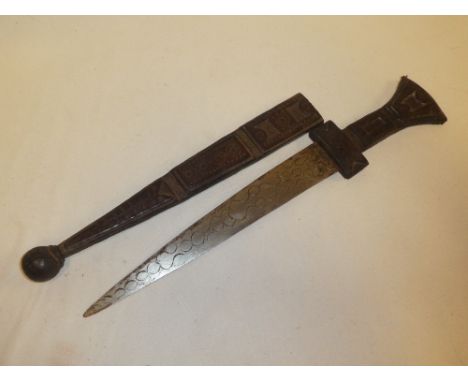 An African dagger with double edged steel blade in tooled leather hilt and scabbard