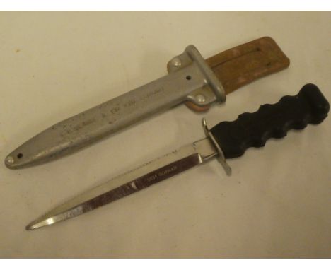 A Siebe-Heinke underwater swimming knife with 6" blade marked "Siebe Gorman", rubber hilt in aluminium scabbard marked "CE He