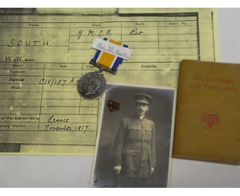 A British War medal awarded to Rev. W. South YMCA with original postcard portrait photograph, YMCA Soldiers New Testament and