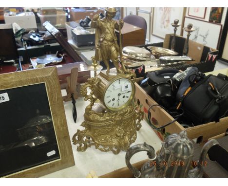 A gilt mantle clock surmounted with huntsman