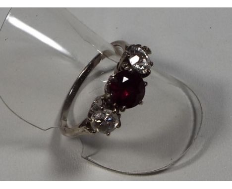 A lady's ruby and diamond three stone presumed 18ct white gold, approx diamond weight 0.7 of a carat, 4.27grams, (all in) siz