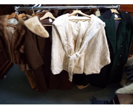 Four lady's coats, one light brown fur coat marked Leeds Boston, approximate length 60 cm , a brown coat with fur trimmed col
