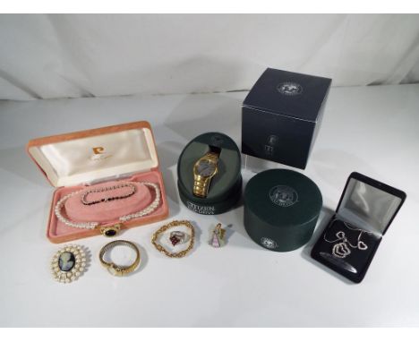 A mixed lot of predominantly costume jewellery to include a necklace and earring set, a ring, a brooch, a Wade collector's en