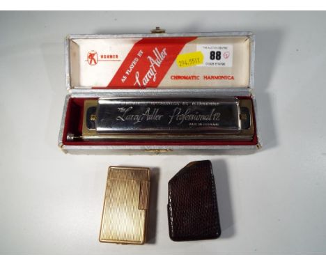 Hohner - a Chromatic Harmonica 'The Larry Adler Professional 12', Germany in case and a MC Dupont cigarette lighter in leathe