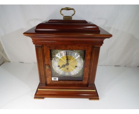 A 17th century style American stained beechwood bracket clock, the dial marked Howard Miller, having an eight-day movement, c