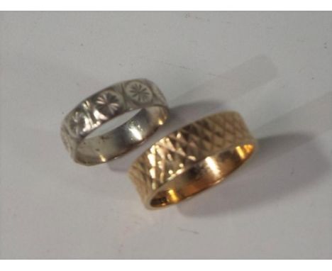 A hallmarked 9 carat yellow gold band, approximately 3.05 grams and a hallmarked silver band