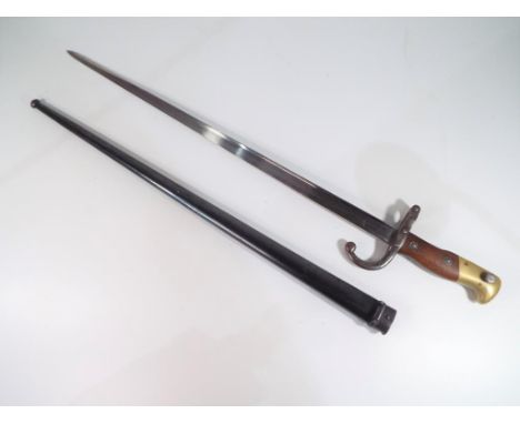 A 19th century French bayonet and steel scabbard, 66 cm (length in scabbard) the blade engraved M d'Avenue de Chatu  8 lire 1