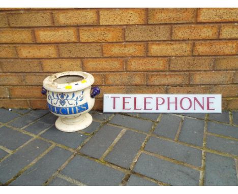 An antique ceramic two-handled leech jar (missing lid) and an original perspex telephone sign. estimate £20 - £40