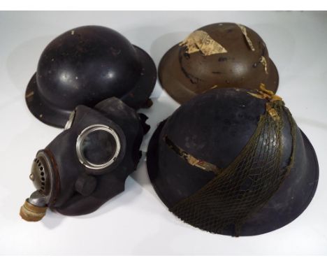 Three British Army helmets comprising World War Two (WW2) BMB 1941, D70 (probably ARP) and later 1952, and a gas mask - [4]