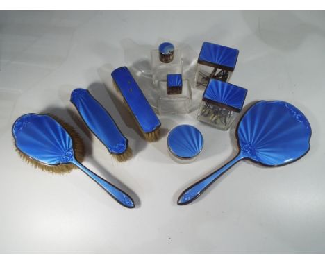 A hallmarked silver nine-piece dressing table set with blue enamelled decoration to all pieces, Sheffield assay 1963