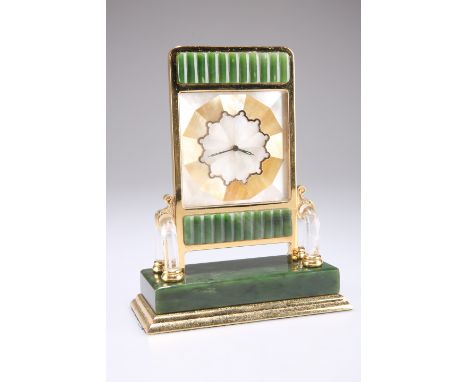A ROCK CRYSTAL AND NEPHRITE JADE CLOCK, IN THE MANNER OF CARTIER,&nbsp;the segmented mother-of-pearl face flanked by a pair o