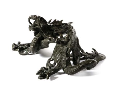 A Chinese Bronze Figure of a Dragon, 19th century, the five-toed beast crouching with head raised29cm wideNo breaks or repair