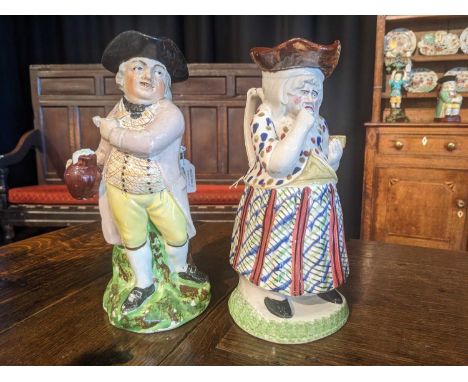 A Pearlware Hearty Goodfellow Toby Jug, early 19th century, on naturalistic mound base and with rustic branch handle26.5cm hi