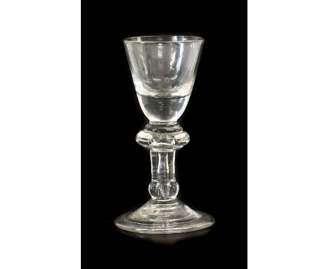 A Dram Glass, circa 1720, the rounded funnel bowl with solid base on an annular knop, plain stem with air tear and basal knop