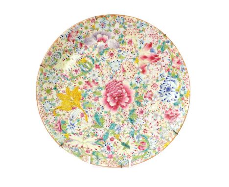 A Chinese Porcelain Charger, Qianlong reign mark but not of the period, decorated in famille rose enamels with a millefiori g