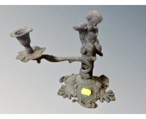 A 19th century cast metal cherub candlestick