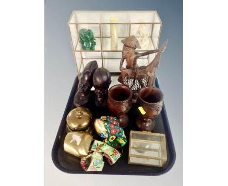 A tray of two carved African busts, further figure, pair of goblets, brass and glass display stand containing carved hardston