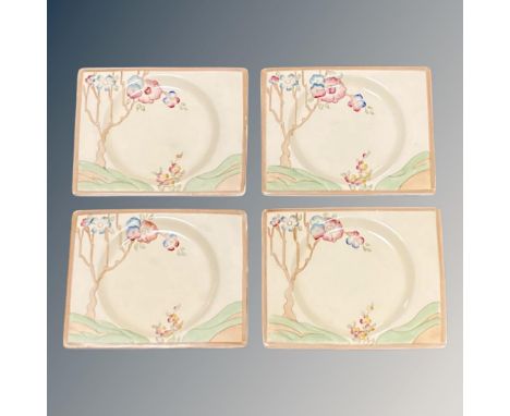 A set of four Clarice Cliff rectangular cabinet plates, each 7 cm x 4 cm, reverse marks 'The Biarritz Royal Staffordshire'. (