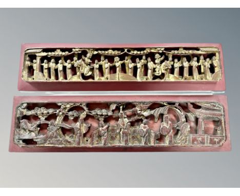 Two early 20th century Chinese carved and gilt temple panels depicting figures in traditional dress, longest 64 cm