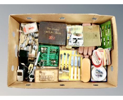 A box of cutlery sets, vintage first aid box, boxed coasters, novelty corkscrew, vintage mobile phones 