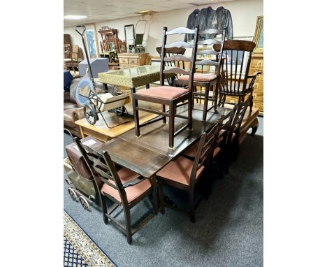 An oak pull out extending dining table, total length 176 cm and six ladder back chairs 