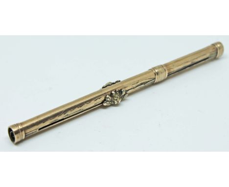 A gold plated propelling tooth pick.  