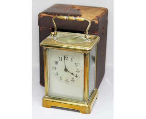 A French brass carriage clock, height 14cm, with leather case.  