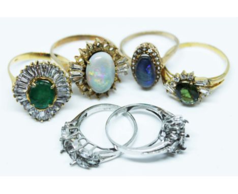 A mixed lot of dress rings comprising a ballerina style ring marked '18K' gross wt. 6.6g size W, an opal cabochon ring marked