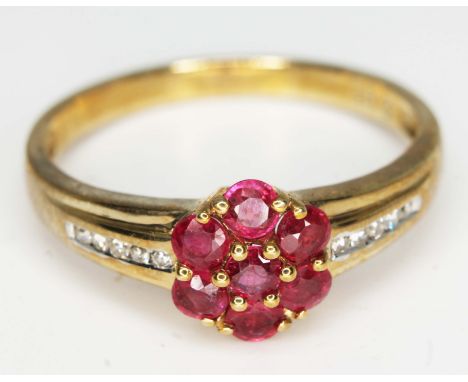 A hallmarked 9ct gold diamond and ruby cluster ring, gross wt. 2.9g, size V, with box.  