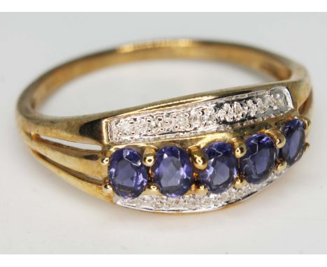 A hallmarked 9ct gold cluster ring set with diamonds and tanzanite coloured stones, gross wt. 2.7g, size V, with box.  