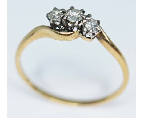 A three stone diamond ring, band indistinctly marked, gross wt. 2.2g, size U.  