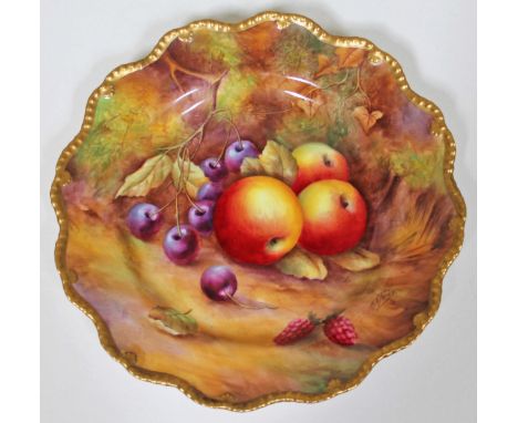 A Royal Worcester porcelain plate with crimped rim and decorated with fruit within a gilt border, signed H H Price, diam. 22c