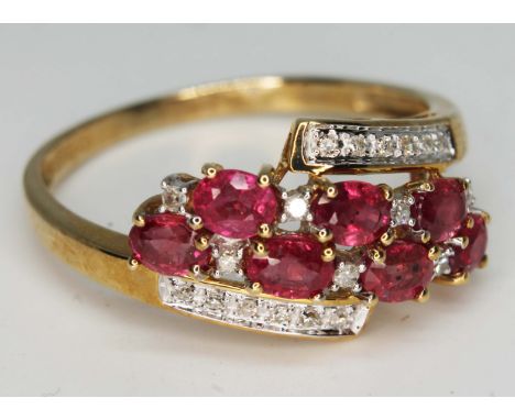 A hallmarked 9ct gold diamond and ruby cluster ring, gross wt. 3.1g, size W, with box.  