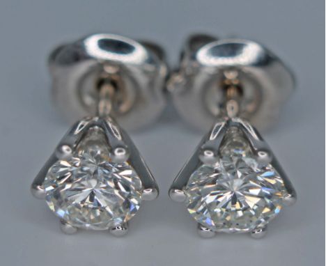 A pair round brilliant cut diamond stud earrings, each stone approx. 0.62 carats, crafted in 18ct white gold, unmarked, gross