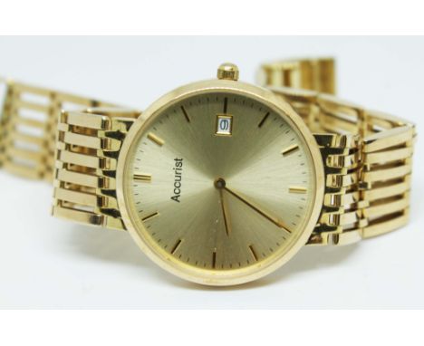 A hallmarked 9ct gold unisex Accurist wristwatch on gold strap marked 9ct, with quartz movement in slim case, case diameter 3