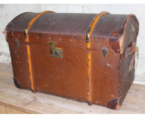 A vintage wooden bound and domed top travel trunk with leather handles and interior tray, length 85cm.  