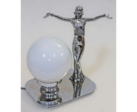 An Art Deco lamp formed as a chrome plated dancing girl on silver plated base with glass globe shade, height 29cm.  