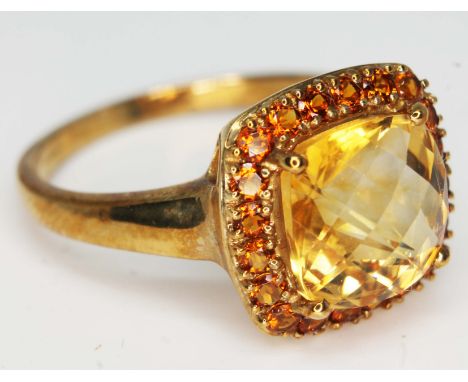 A hallmarked 9ct gold ring set with a large citrine coloured stone, gross wt. 4.5g, size W, with box.  