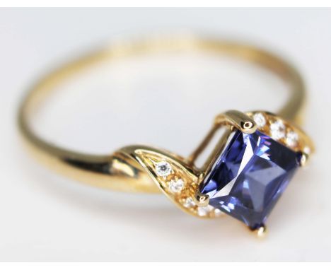 A hallmarked 9ct gold ring set with diamonds and a tanzanite coloured stone, gross wt. 2.5g, size U, with box.  