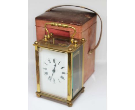 A four glass brass carriage clock, the dial with Roman numerals and inscribed 'France', height 14cm, with leather case.  