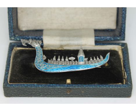 A vintage Siamese silver and blue enamel brooch formed as a dragon boat, length 7.5cm, with box.  
