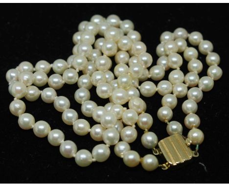 A two strand cultured pearl necklace with 9ct gold clasp, length 42cm, gross wt. 41.9g.  