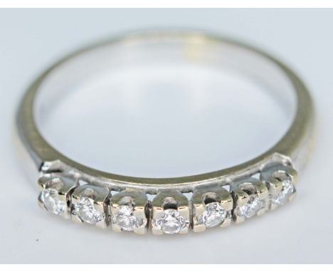 An 18ct gold seven stone diamond ring, marked '750', gross wt. 3.4g, size N.  