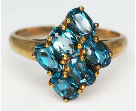 A hallmarked 9ct gold ring set with blue coloured stones, gross wt. 3.8g, size W.  