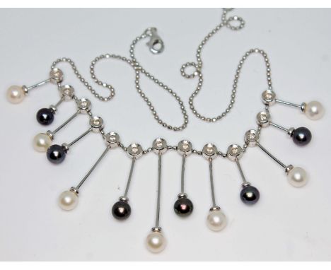 A contemporary 18ct white gold cultured pearl and diamond necklace, marked '750', gross wt. 17.5g, length 42cm, with light wo
