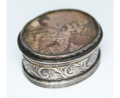 A white metal snuff box of oval form with Indian miniature portrait to top, length 35mm.  