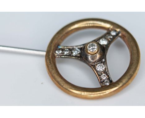 A novelty diamond stick pin formed as a steering wheel, hallmarked 9ct gold, gross wt. 2.6g, diam. 18mm.  