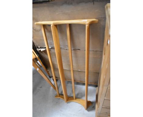 A light Ercol wall mounted plate rack